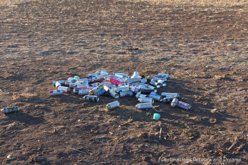 Paint cans litter field at Cadillac Ranch