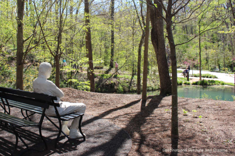 One "person" from the "Three People on Four Benches" sculpture by George Segal "watching people on the trail