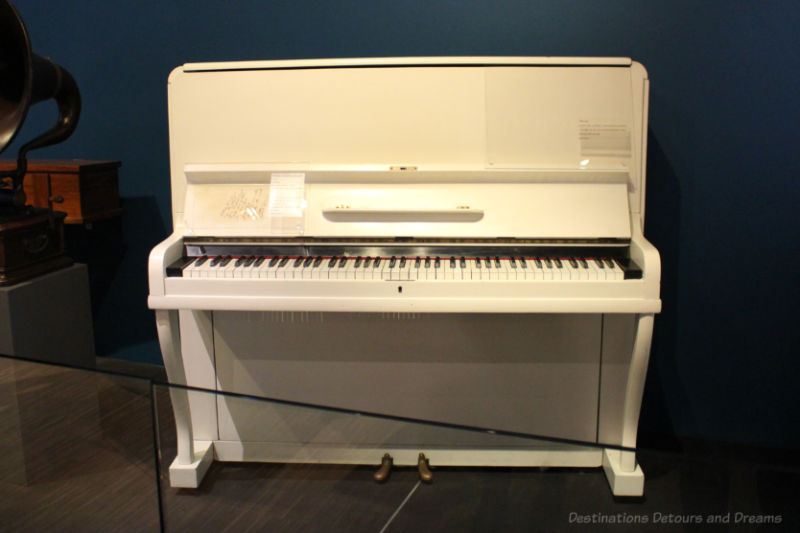 Vertical white "birdcage" piano, circa 1910