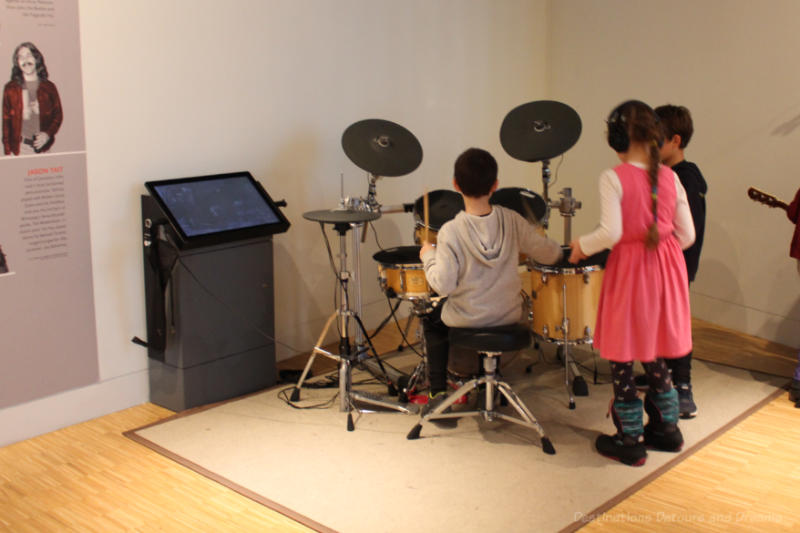 A group of children playing the drums at the National Music Centre