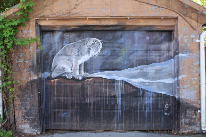 Painting of a lynx on a garage door in Arctic Alley, Winnipeg