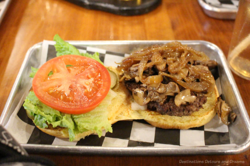 A burger with caramelized onions and fried mushrooms