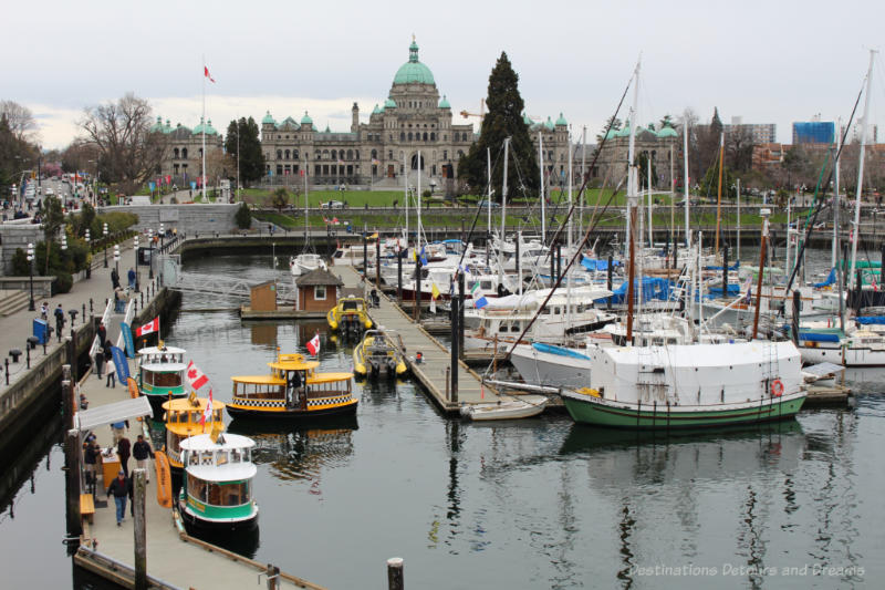 Boats in Victoria Inner Harbour with view of British Columbia Parliament Building in background