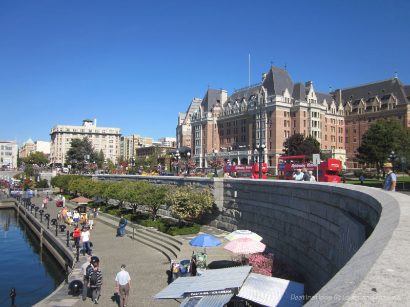 Pedestrian walkway in the lower causeway of Victoria Inner Harbour with the iconic Empress Hotel in the background