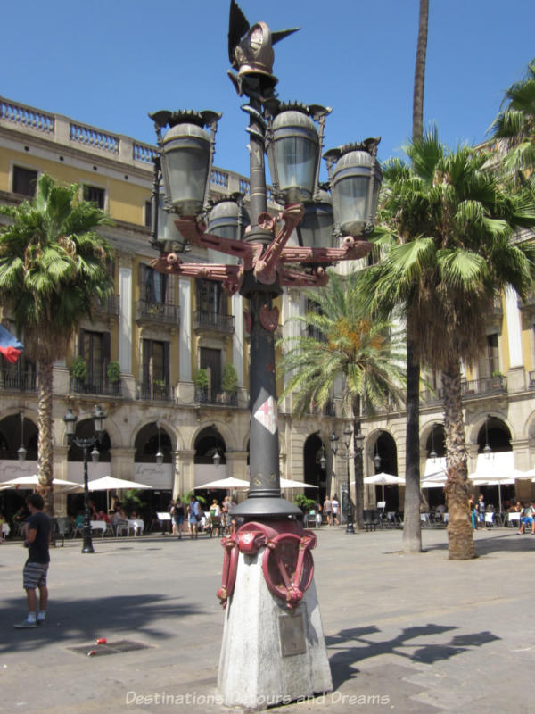 Gaudí lamp post with six arms for gas lights and crowned with a winged helmut