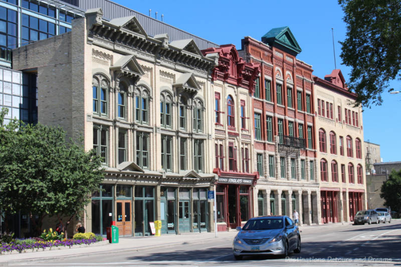Facades of several early 20th century buildings on the front of a new build in Winnipeg's historic Exchange District. 