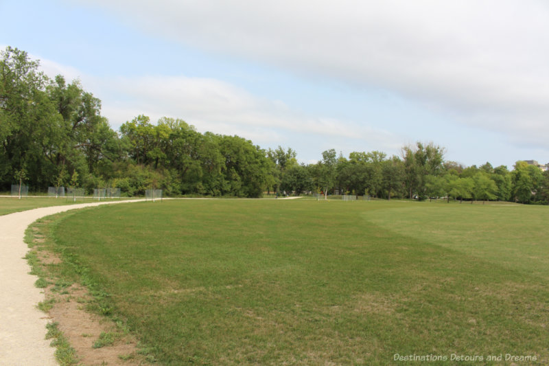 Green lawn surround by walking path and trees