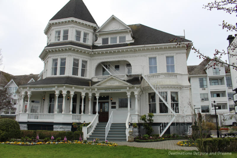 Victoria Pendray Inn Victorian era three-story white mansion with large veranda now an inn and tea house