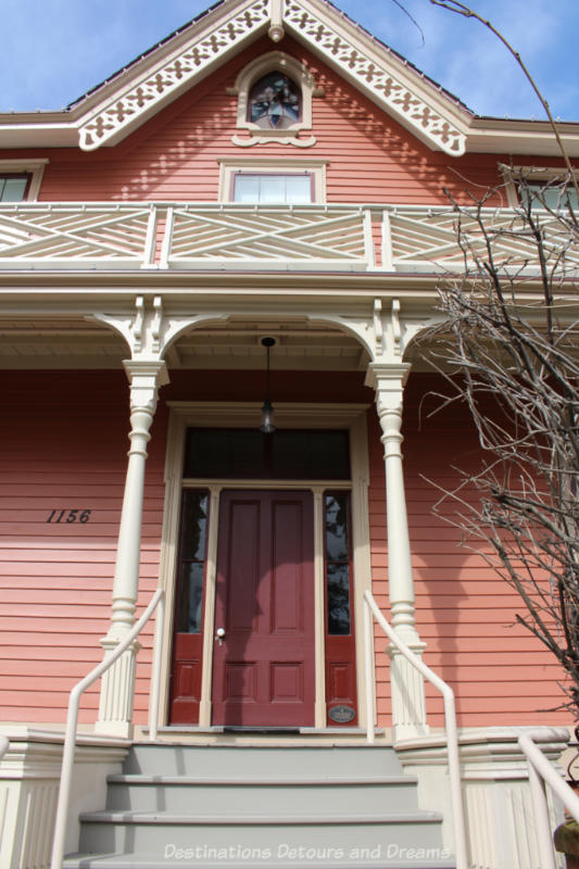 Exterior front entrance to Wentworth Villa: Victoria home with light reddish siding and white trim