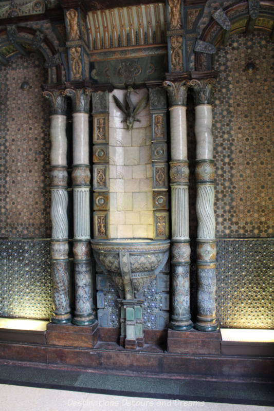 Tiled water fountain with marble and tile pillars on either side in the vestibule of the Lloyds Bank Law Courts Branch