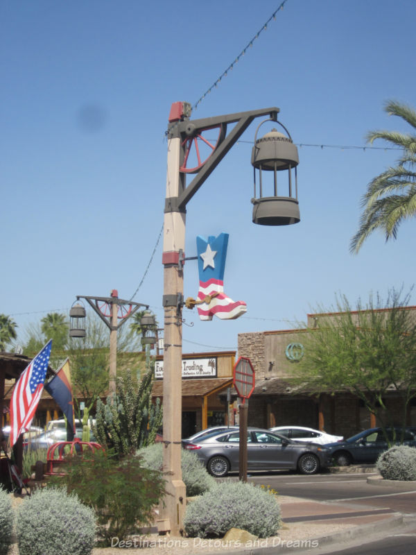 Rustic buildings and signs with flags in Old Town Scottsdale