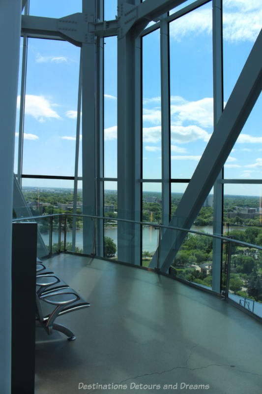Inside the CMHR Israel Asper Tower of Hope looking through tall panes of glass over the Winnipeg landscape