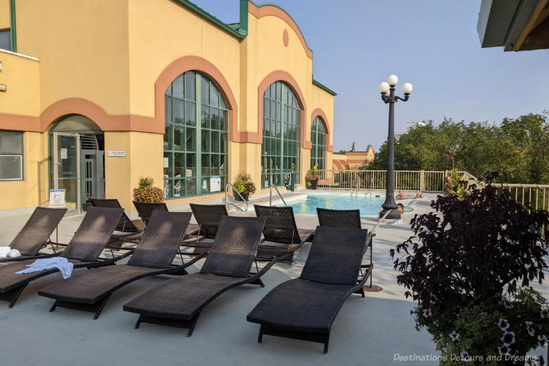 Outdoor pool and deck with lounge chairs on hotel 4th floor patio