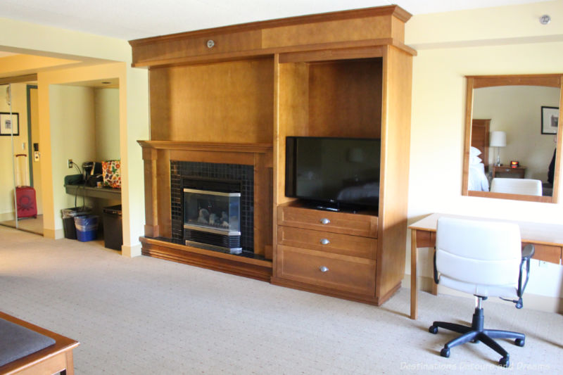 Desk, TV stand, fireplace, and coffee area in hotel room at Temple Gardens Hotel & Spa